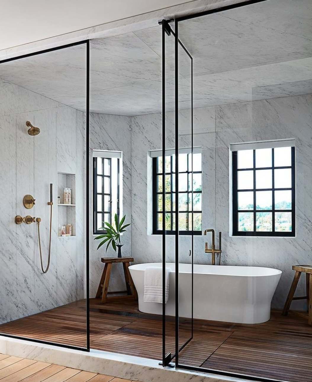 Luxury bathroom renovation by Exell Plumbing NSW — marble walls, freestanding bath, brass fixtures